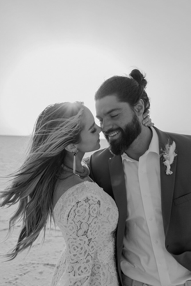 bride with her hand around the grooms neck