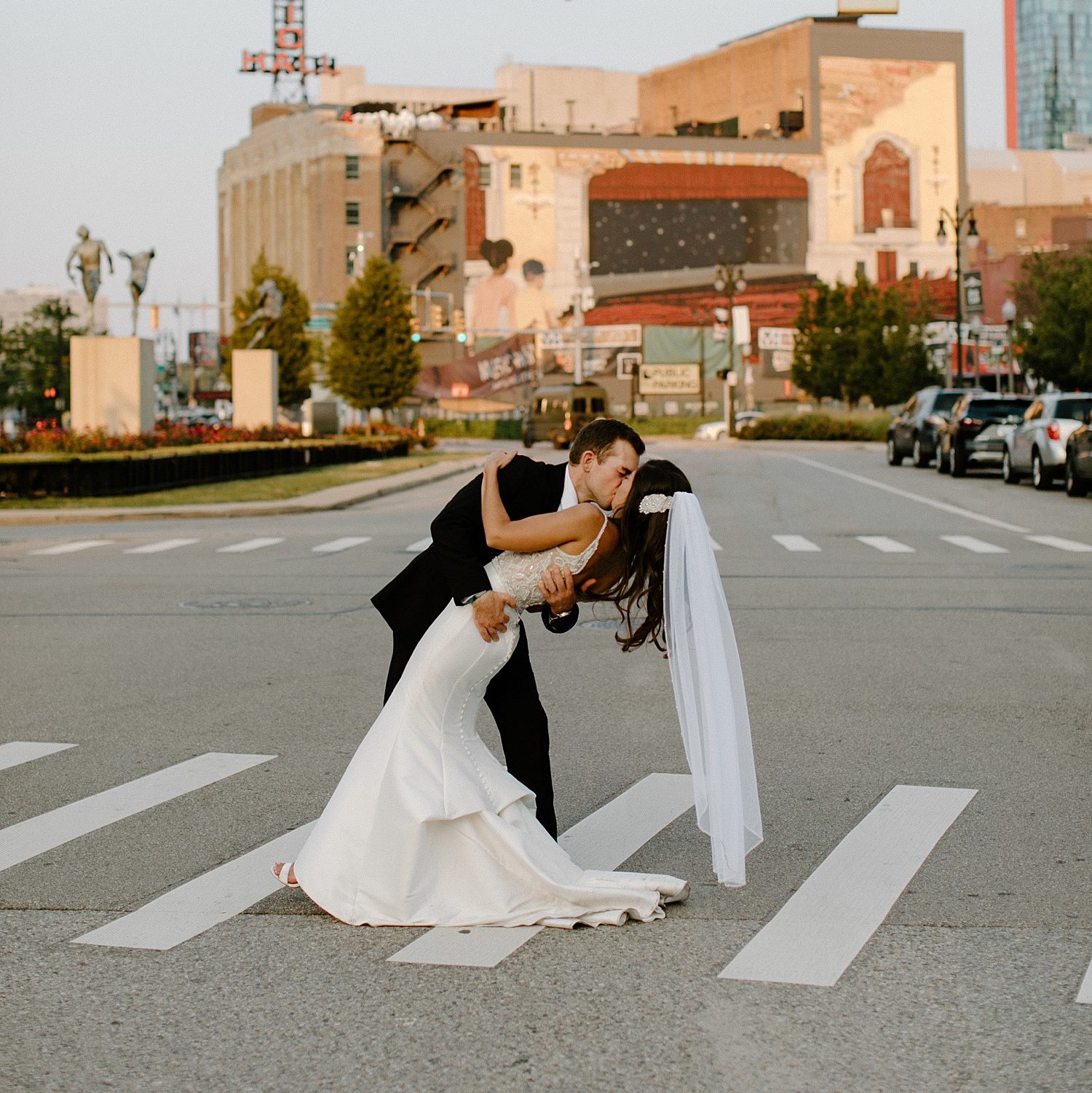 couple kissing in the middle of the street in downtown Detroit on their wedding day