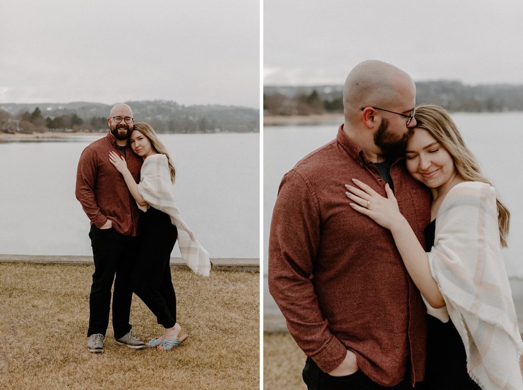 couple hugging while man kisses woman on forehead