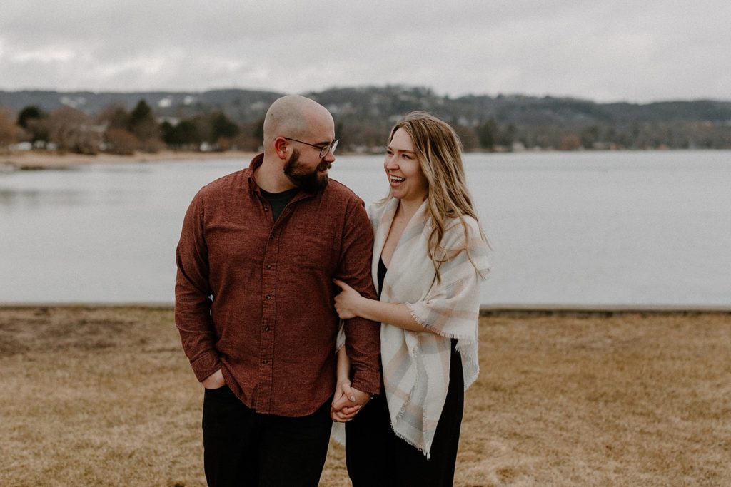 couple holding hands and smiling at each other