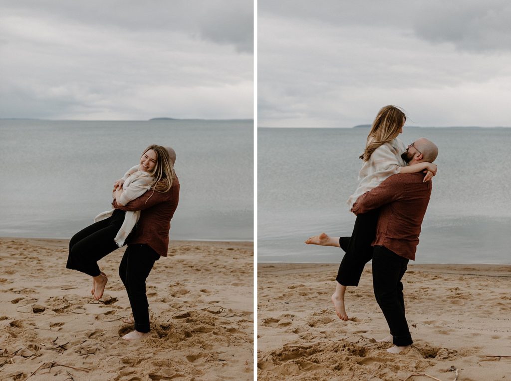 man holding up woman as they smile