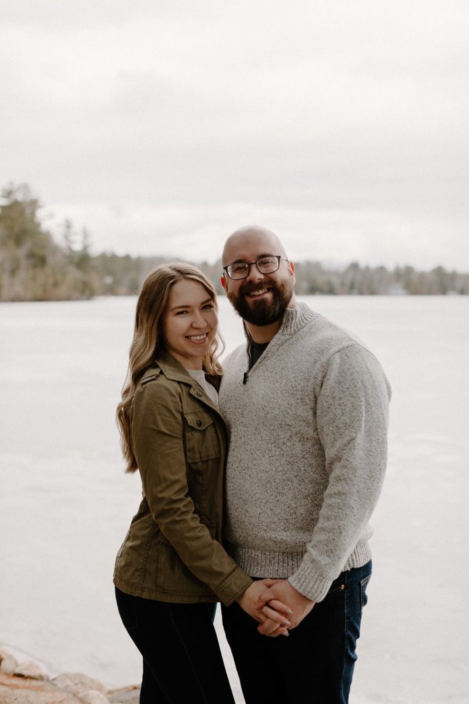 couple standing together holding hands and smiling