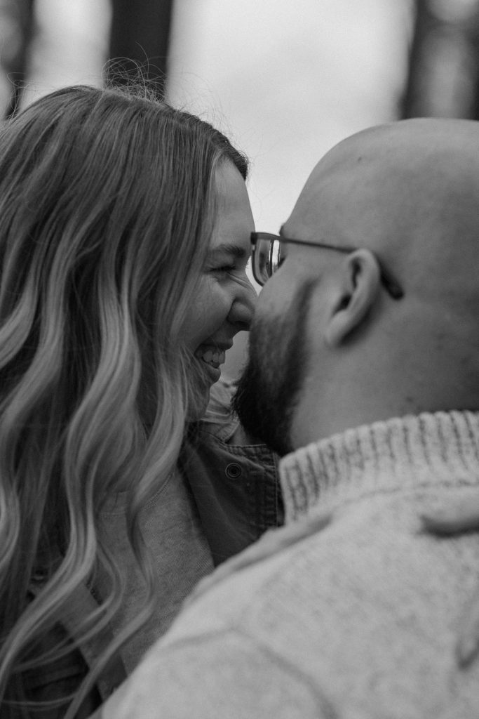 couple standing close together and rubbing noses