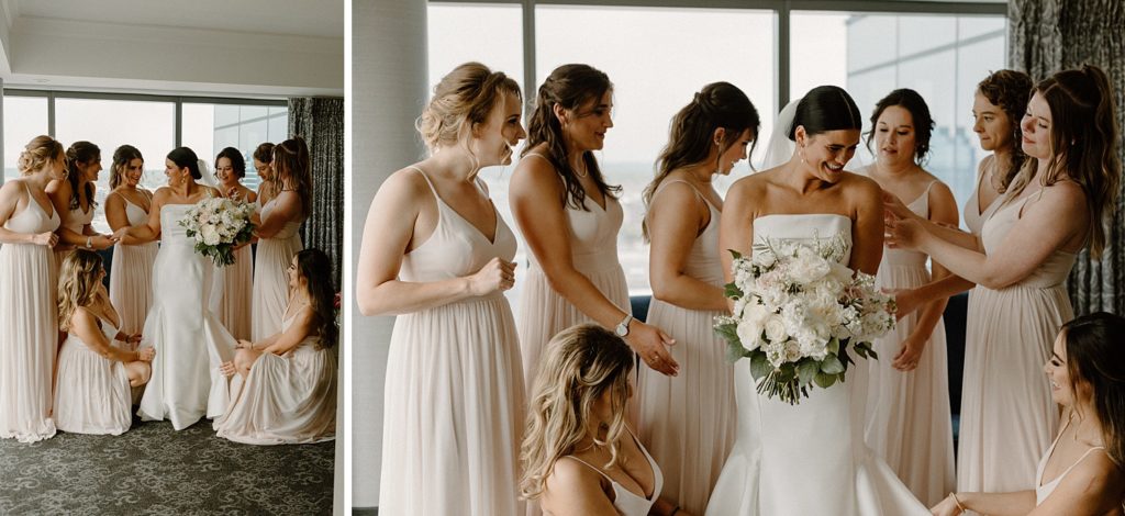 bridesmaids smiling and reaching towards the bride 