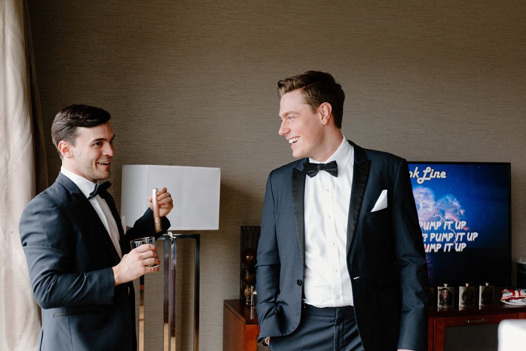 groomsmen smiling and drinking 