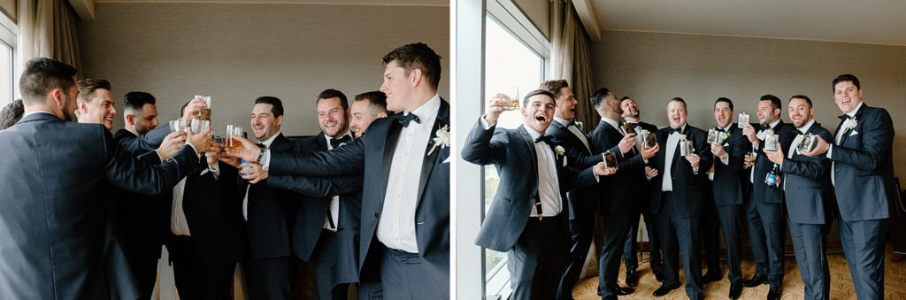 groomsmen standing with groom and toasting 
