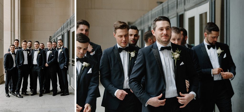 groom standing in front of groomsmen fixing his jacket 