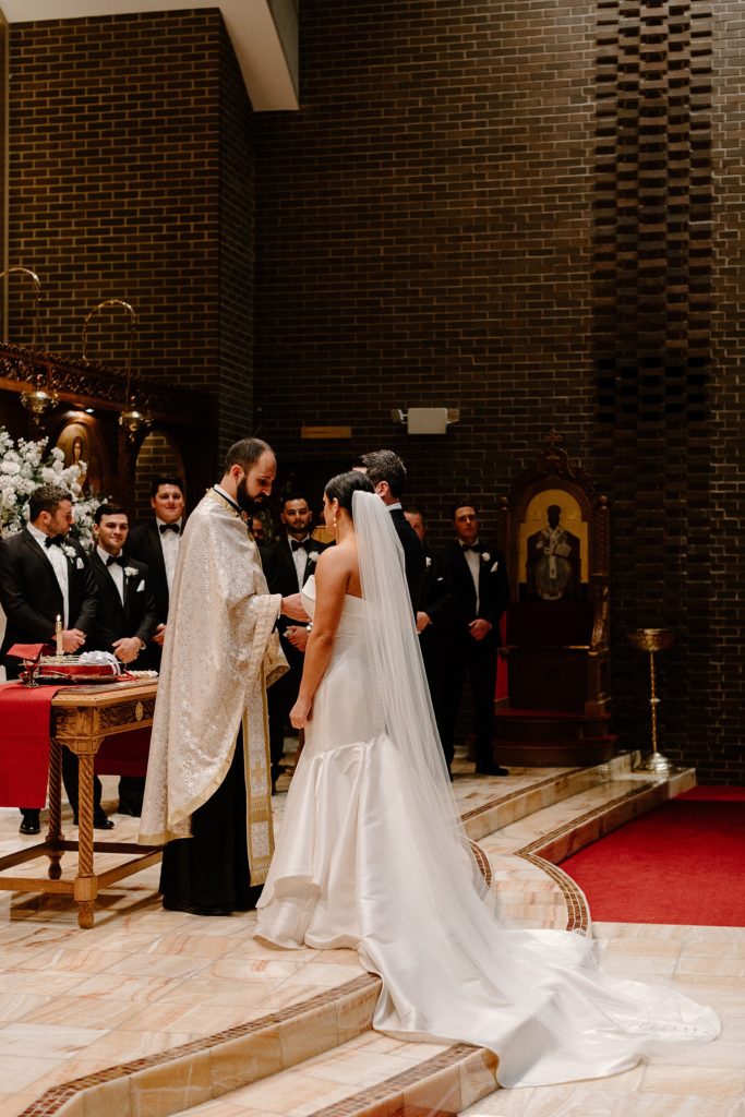 couple standing on the alter with the minister 