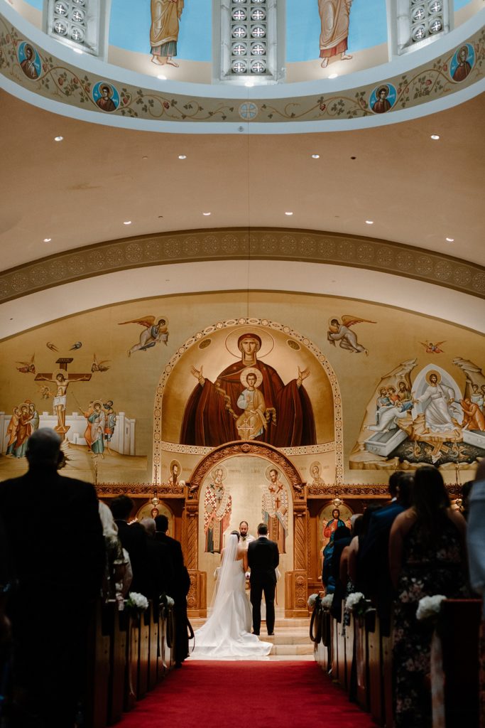 view from the center aisle of the couple on the altar 
