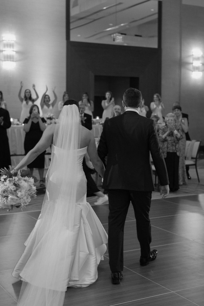 couple holding hands on the dance floor 
