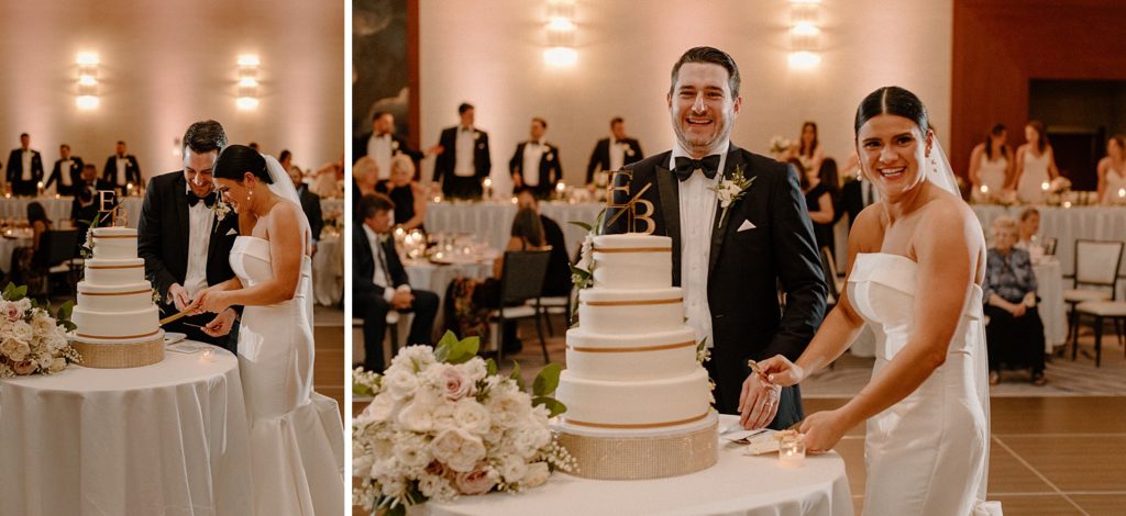couple cutting the bottom tier of the wedding cake 