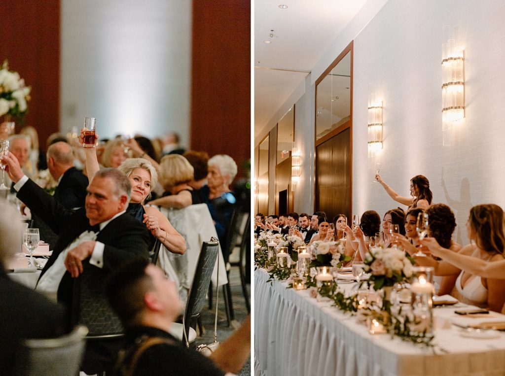 wedding party and guests holding glasses up toasting 