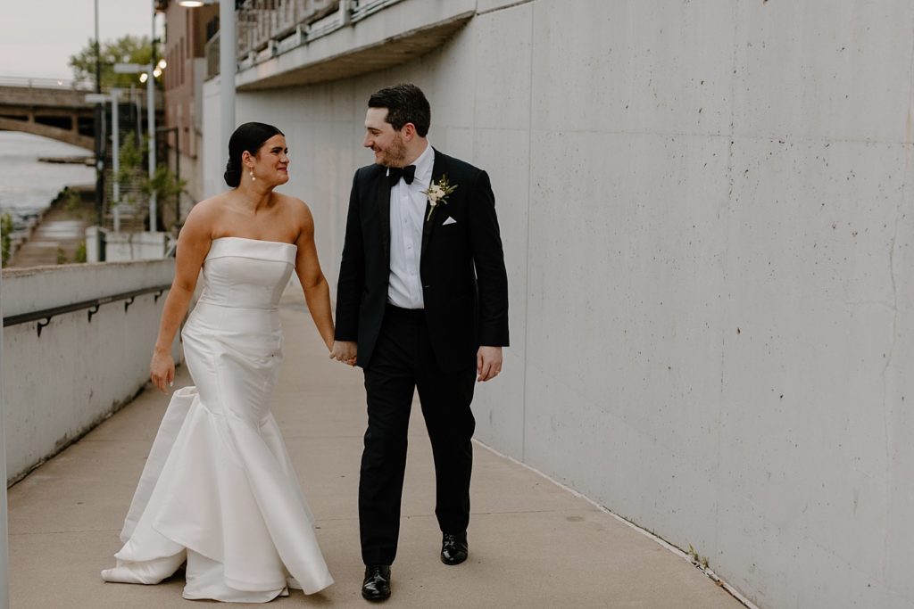 couple holding hands and smiling at each other 