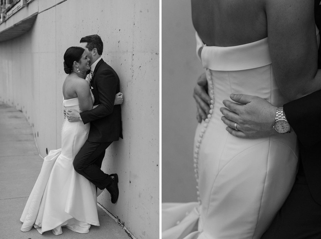 couple hugging and leaning up against a wall 
