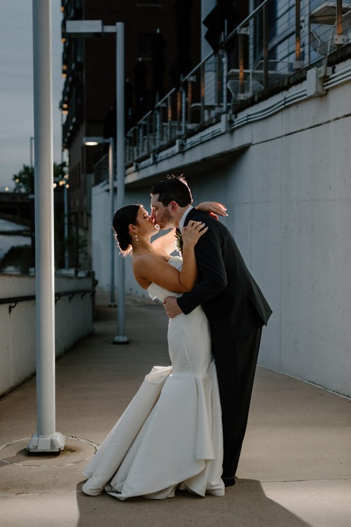 couple sharing a kiss under a street light 