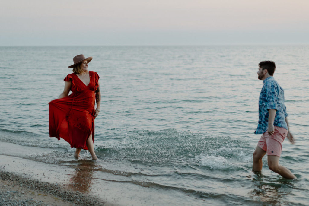 couple walking towards each other at the water's edge