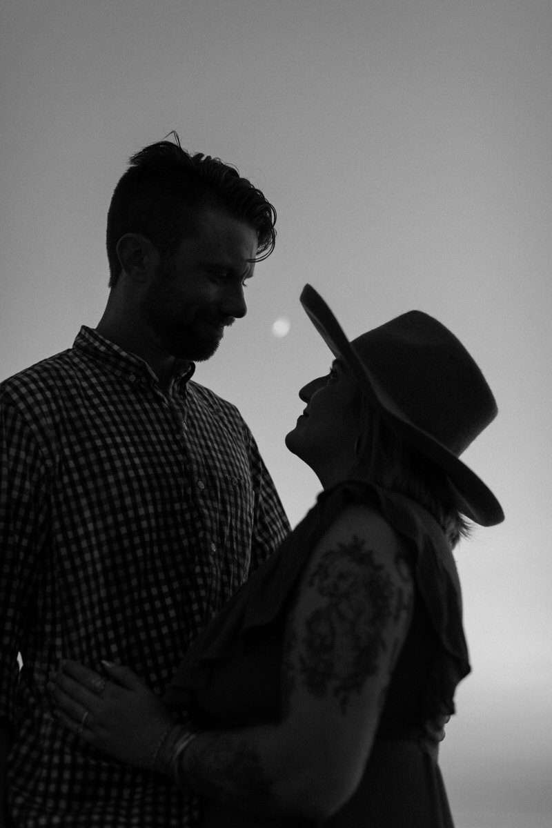 couple holding each other closely and staring into each other's eyes