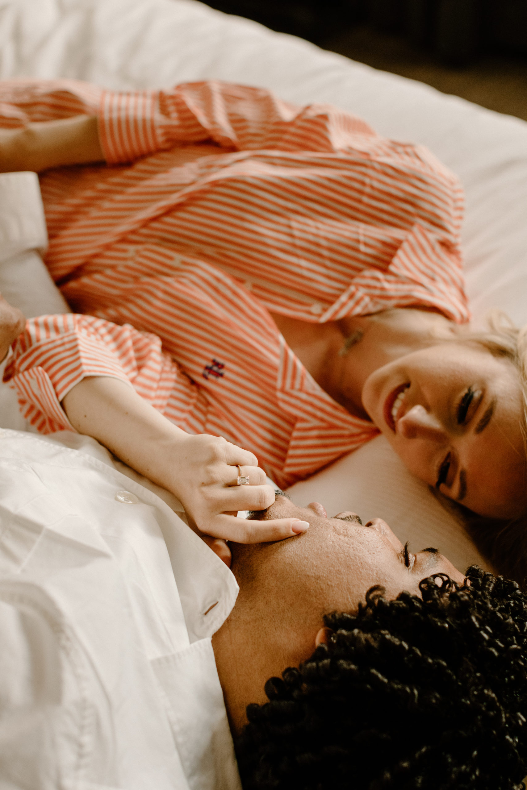 couple in pajamas on hotel bed