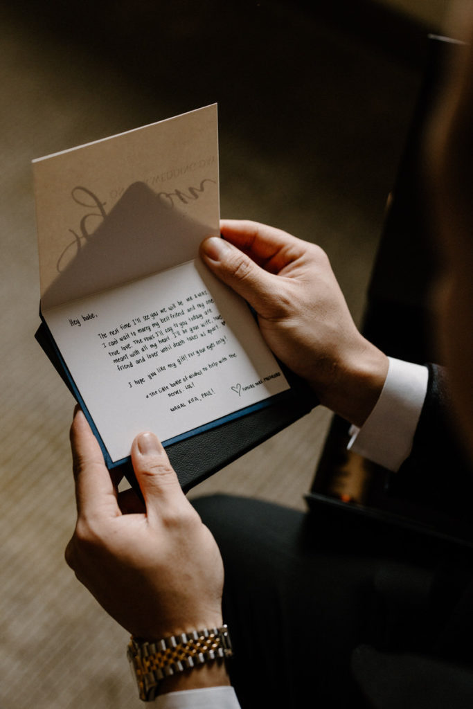 close up view of two hands holding a hand written letter