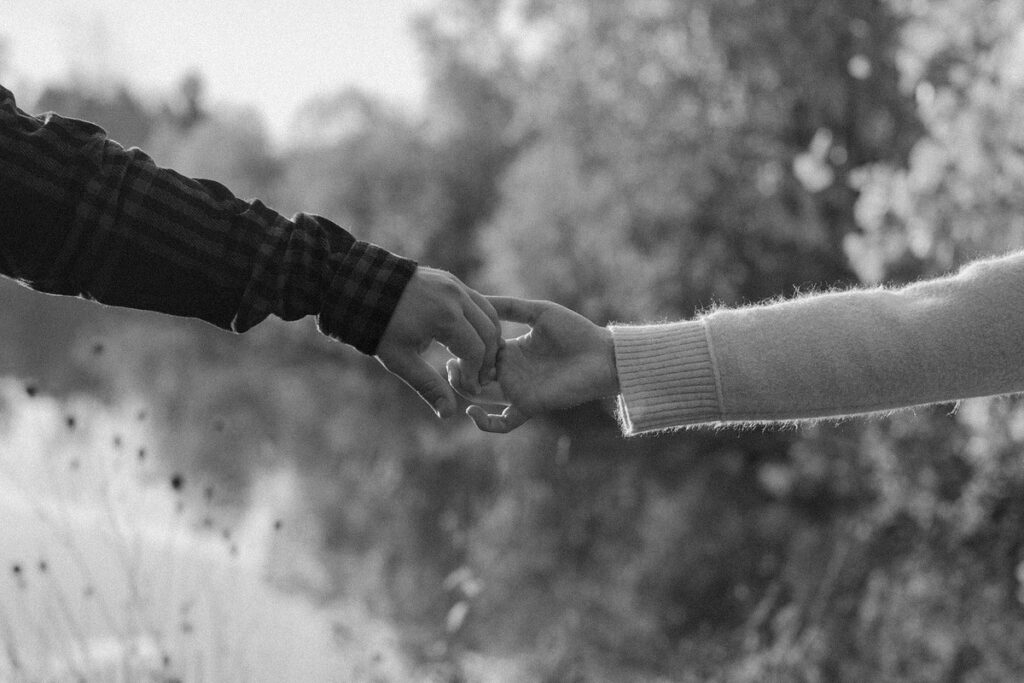 two hands reaching out towards each other